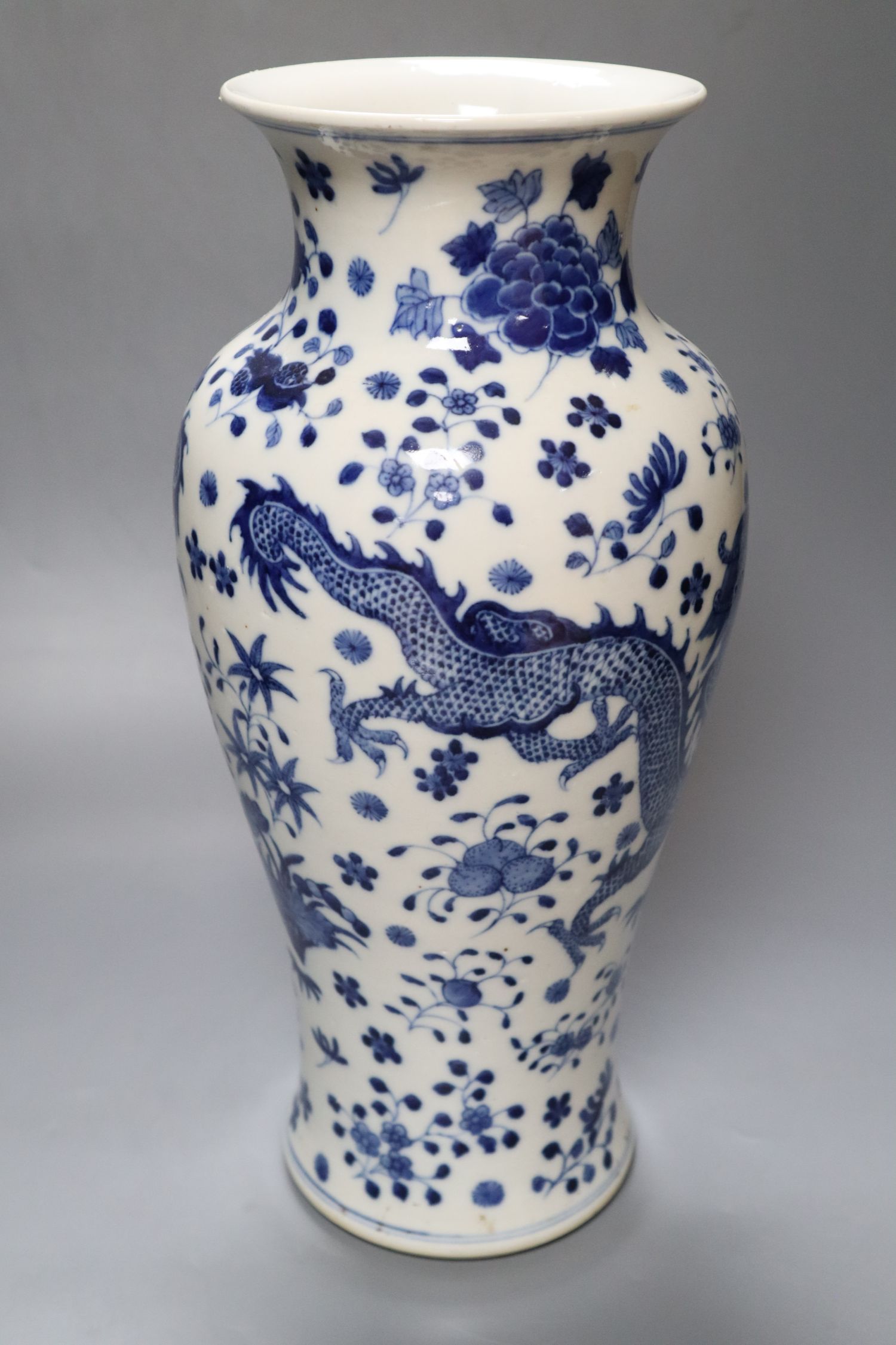 A Chinese porcelain baluster vase, painted with dragons and foliage, height 37cm